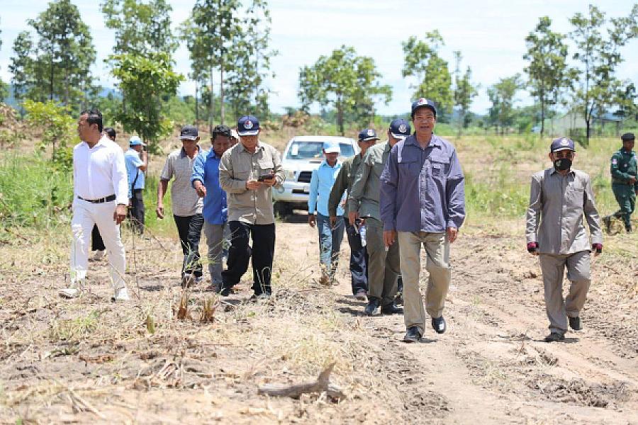 Dr. Kun Kim, a member of the Cambodian Association of Veterans, leads a team to inspect homes for veterans.